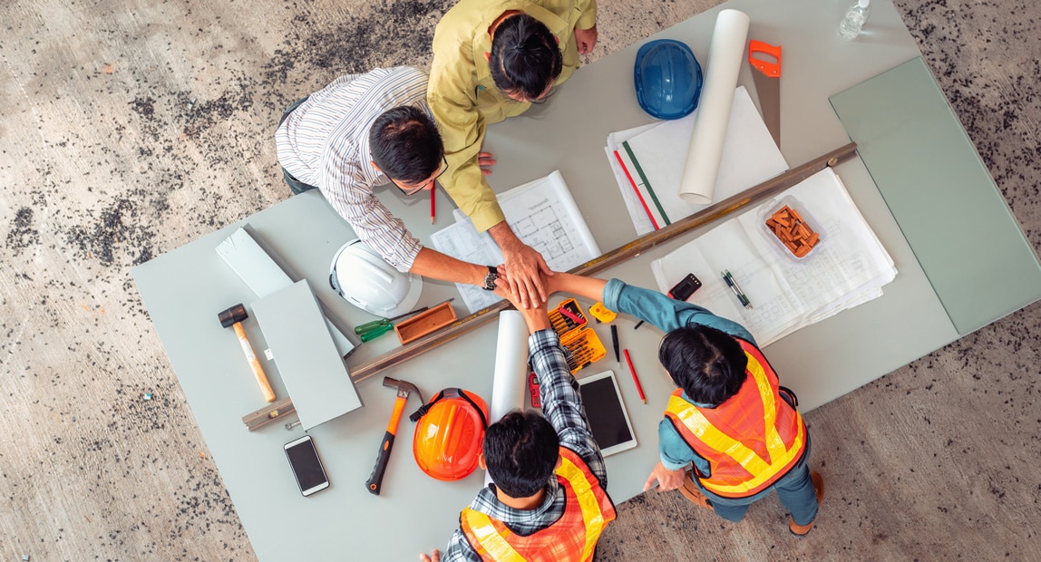 A group of construction workers around a table.