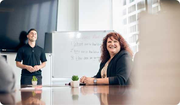 Two Catalyst employees in a conference room.