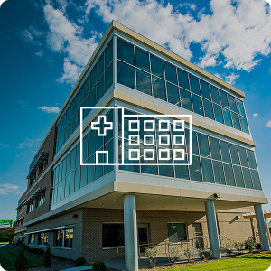 Exterior of a hospital with a hospital icon overlaying image.