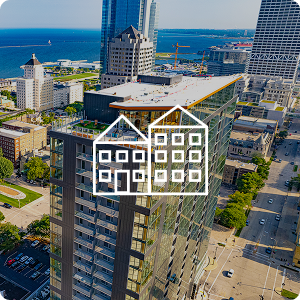 Aerial view of a glass multi-story building with a building icon overlaying image.