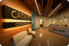 Neenah entrance with a Catalyst Construction sign and some seating.