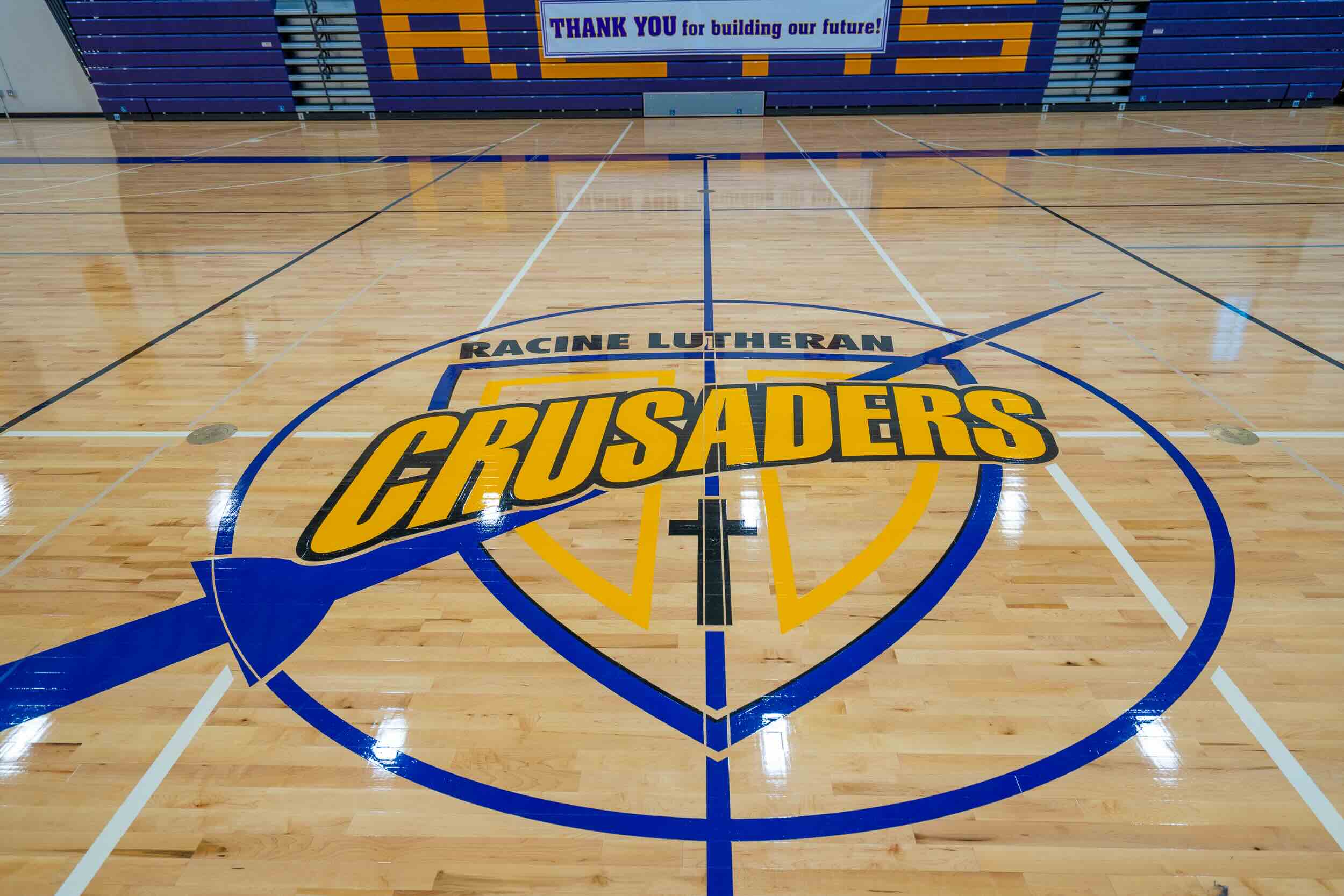 Racine Lutheran High School basketball court half court with their logo: The Crusaders.