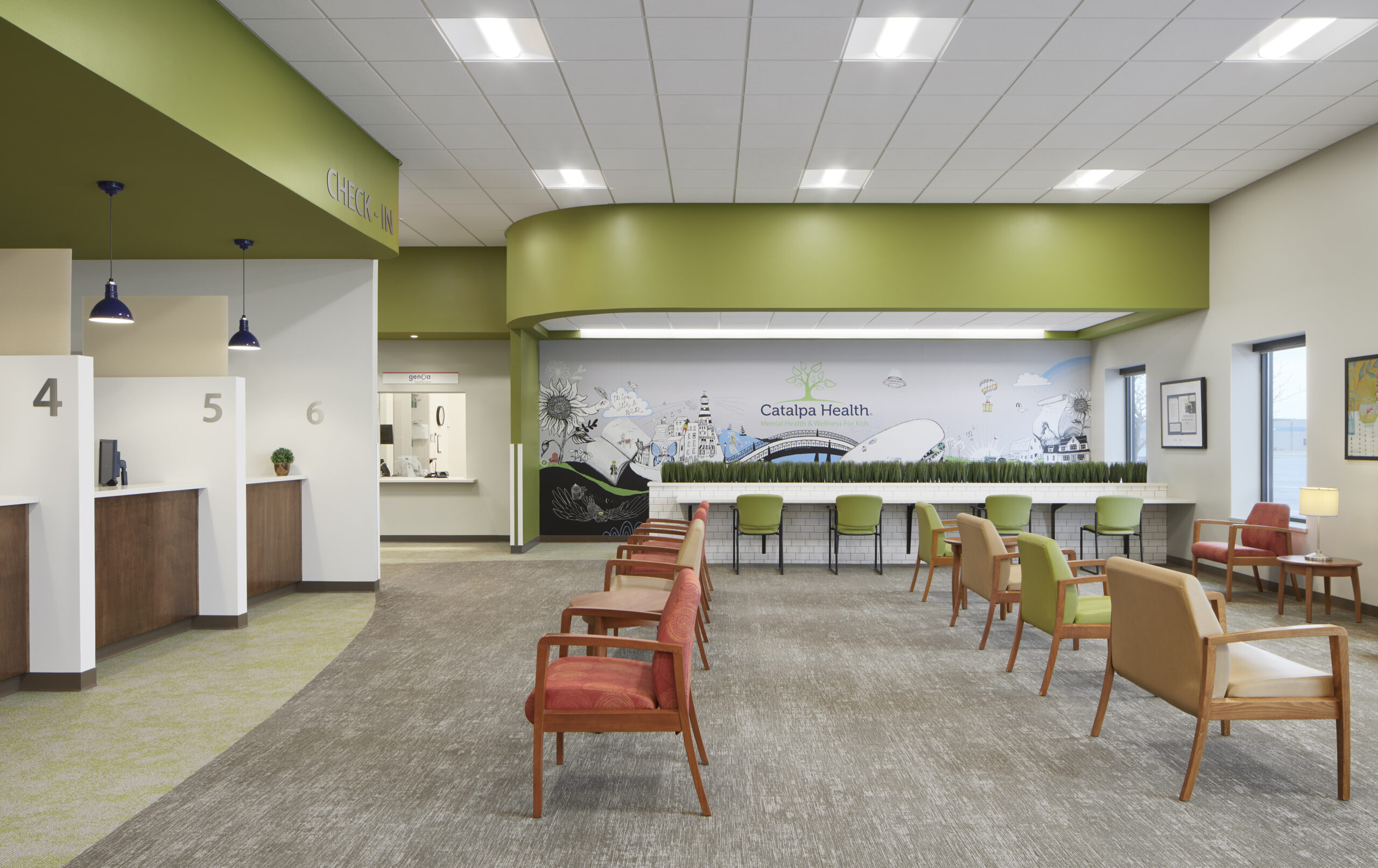 Waiting area with apple green walls and wooden accents.