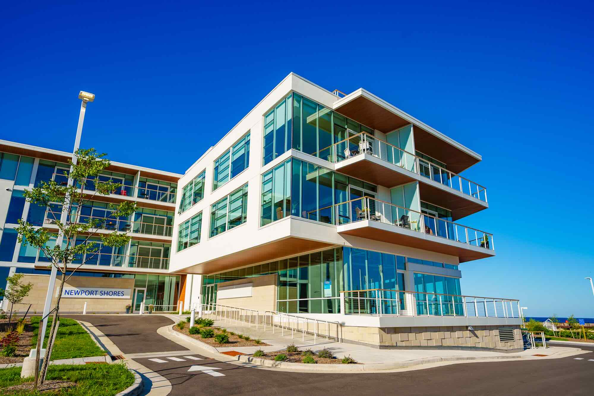 Newport Shores showing a 4-5 storied glass building.