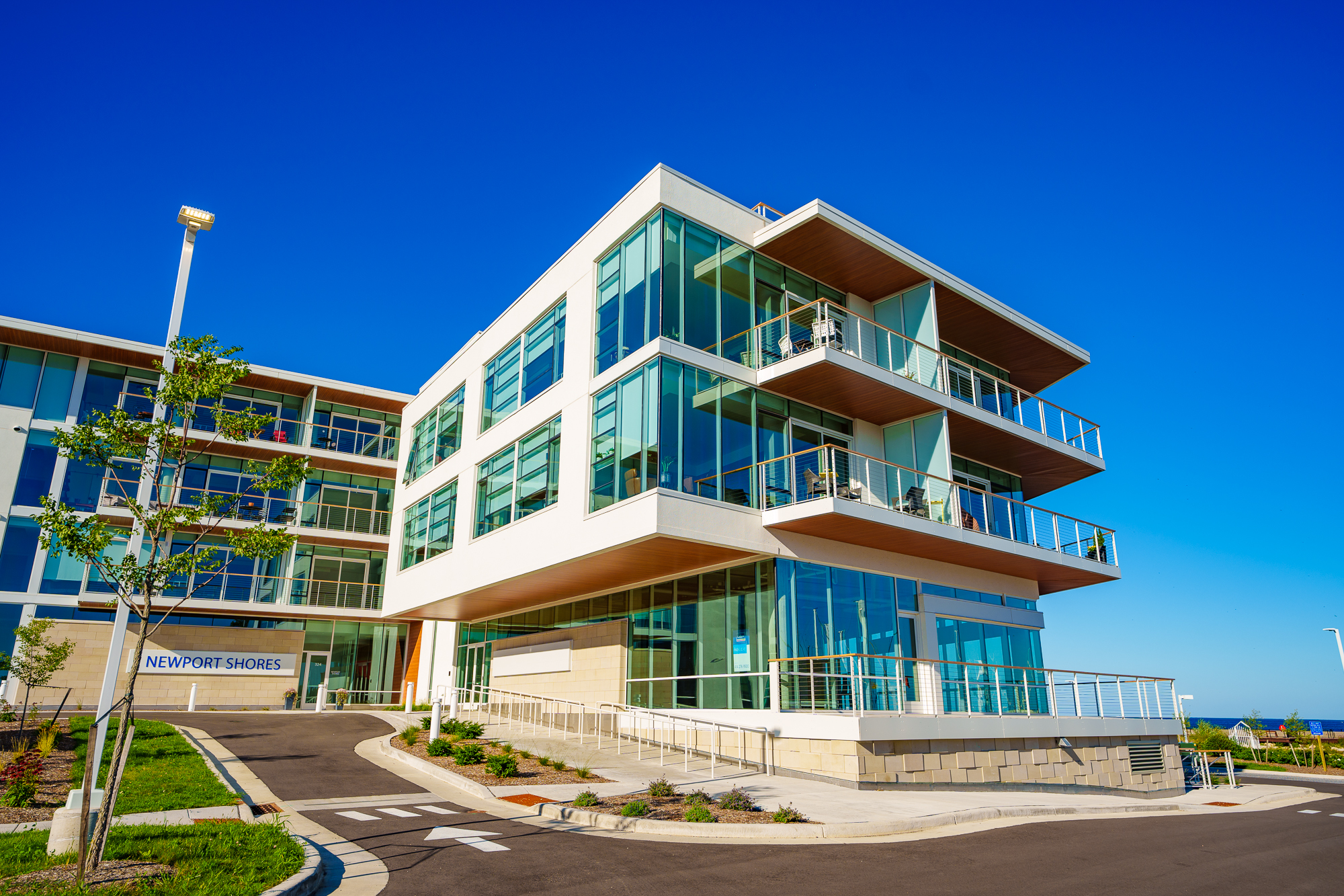 Newport Shores showing a 4-5 storied glass building.