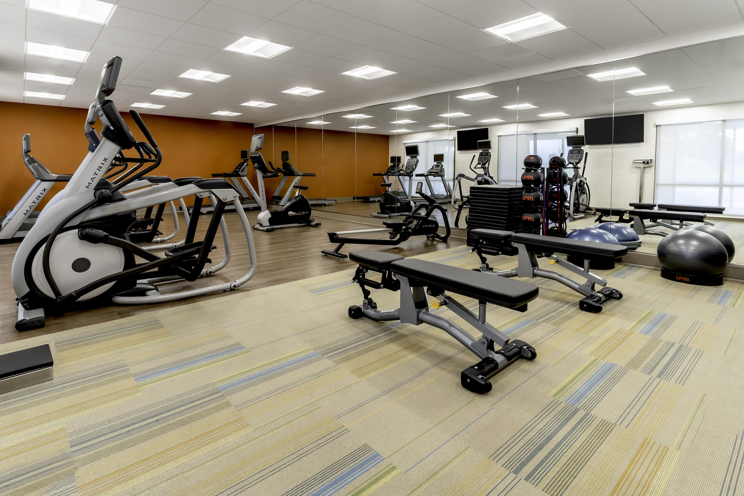 Brightly lit hotel fitness room.