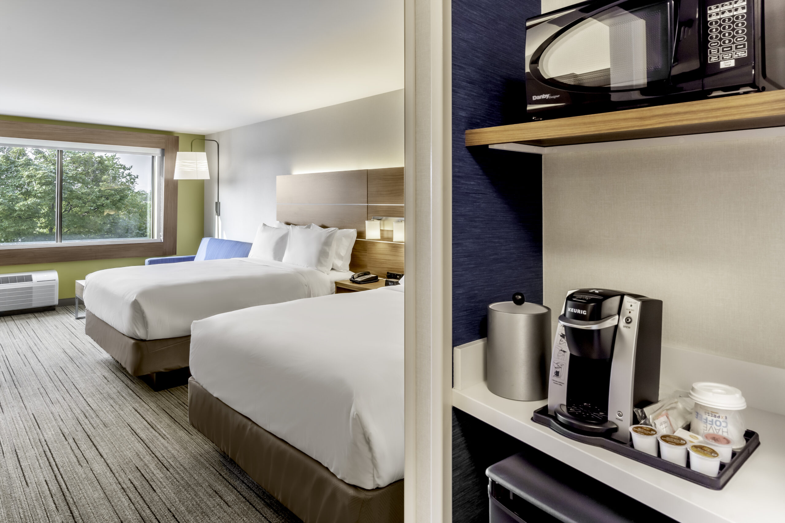 Hotel room with 2 queen beds and a coffee bar.